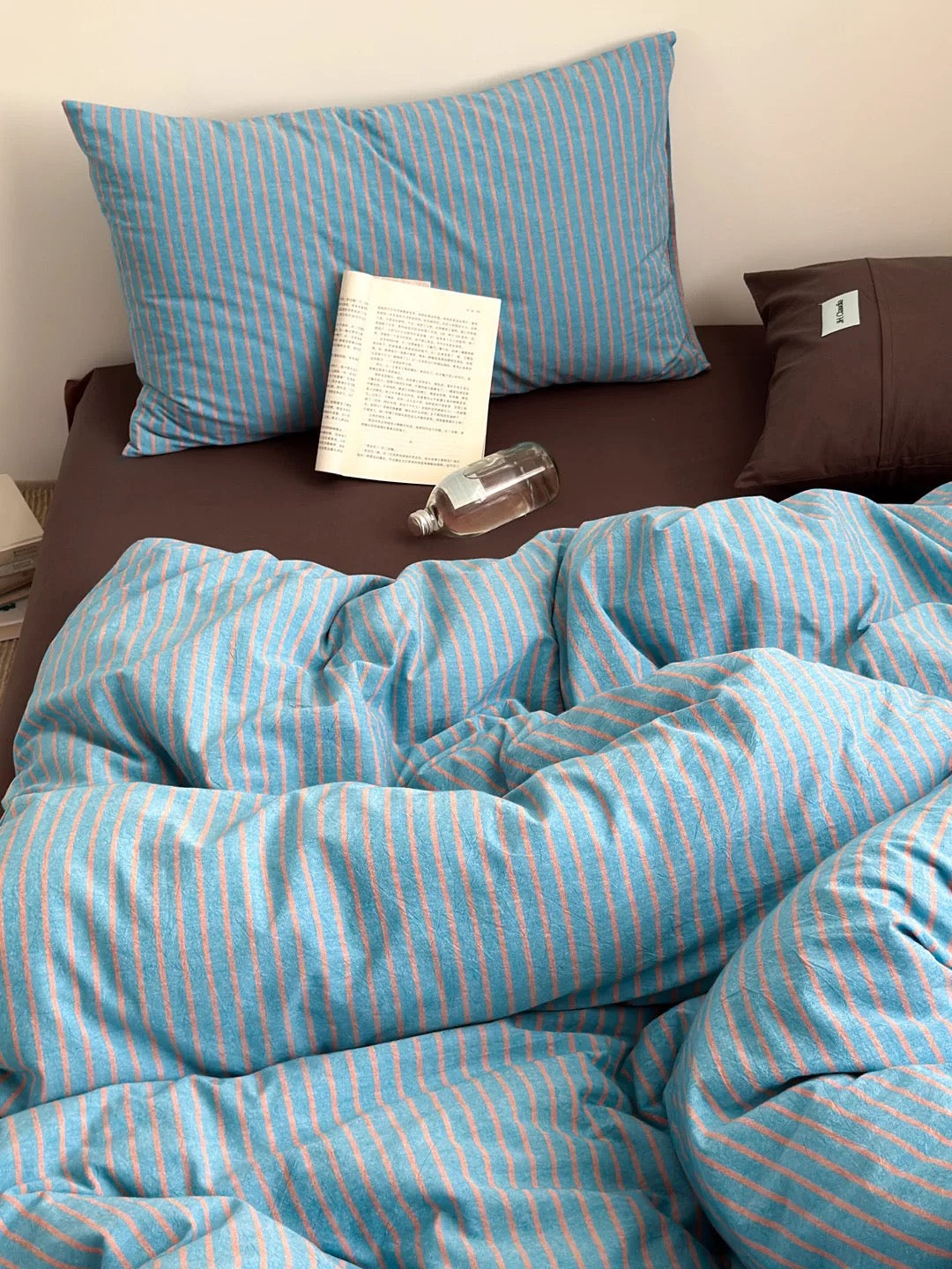 Scandinavian blue stripe bedding – soft duvet cover, brown sheets, apartment bedroom refresh.