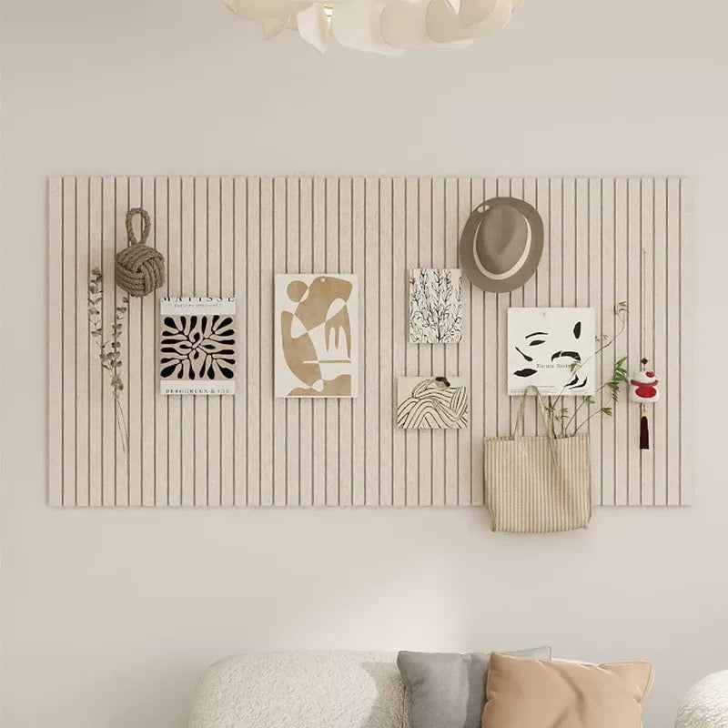 Wall art display with various decorative items on a striped wall