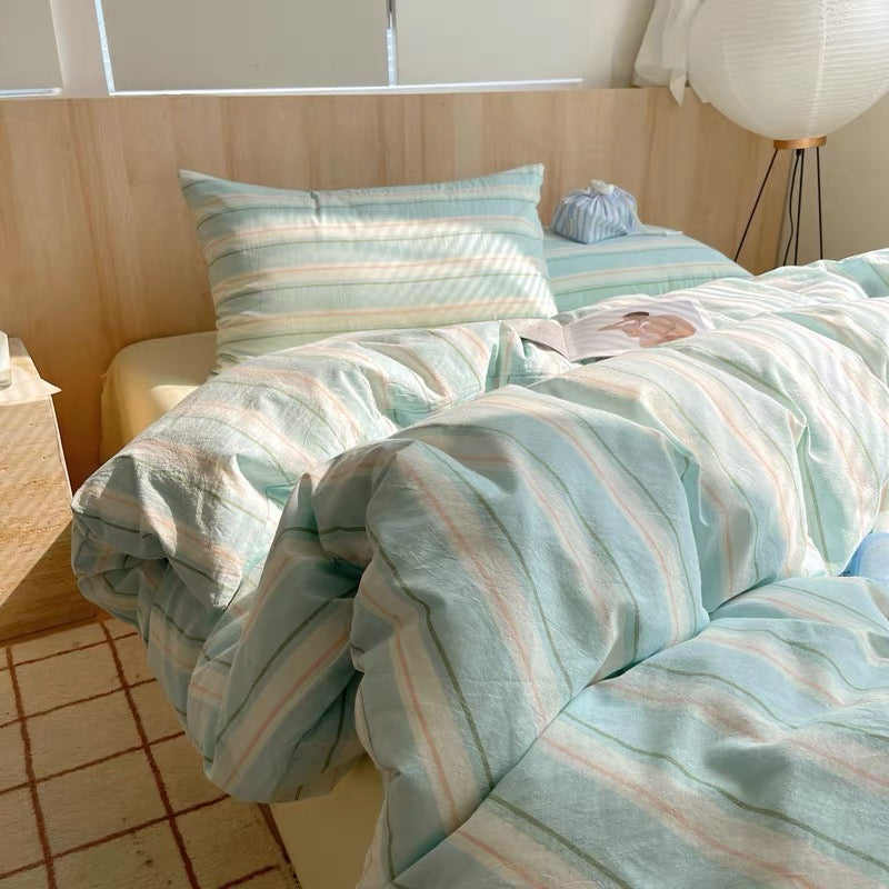 Bed with striped bedding in a bright room