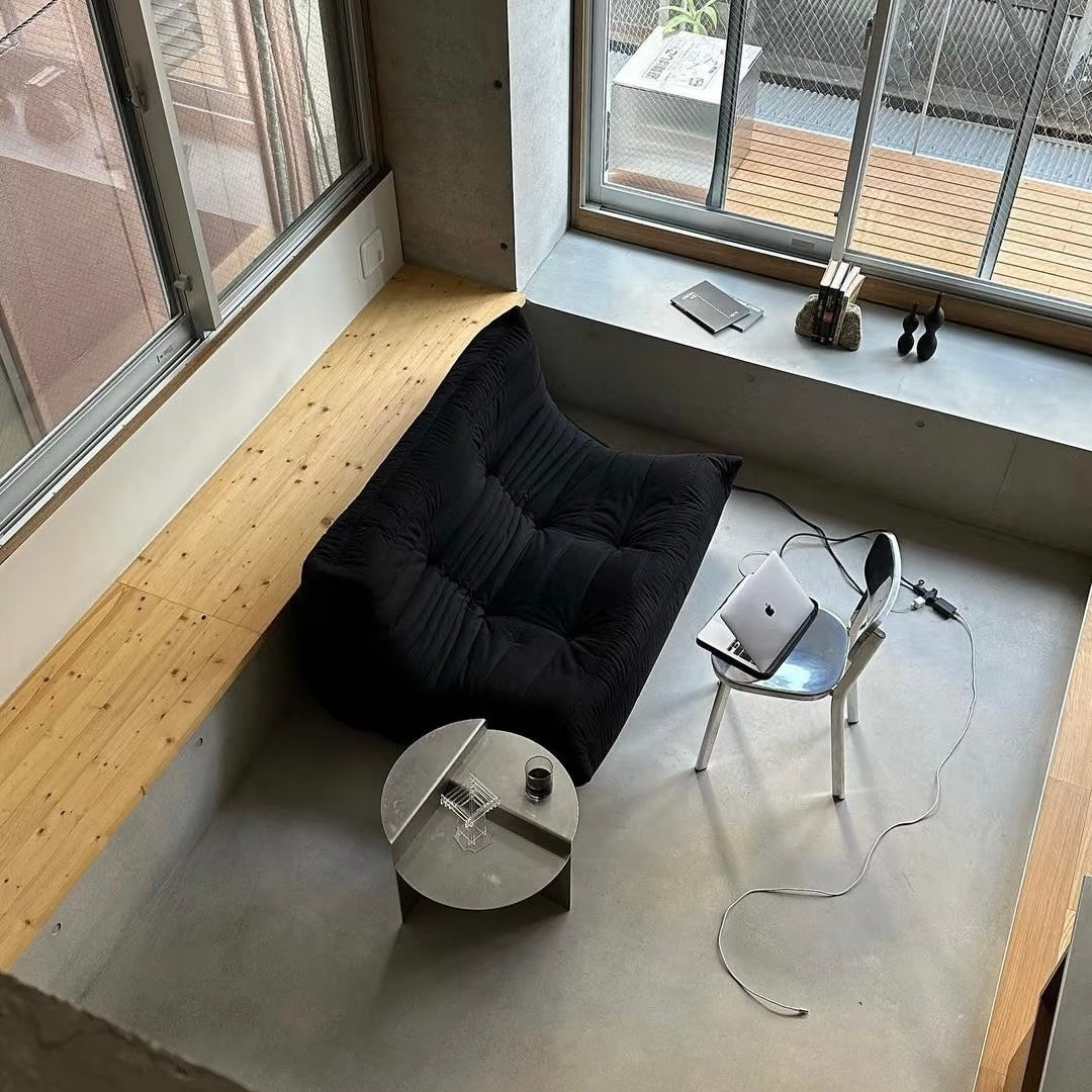 Geometric brushed metal coffee table complementing minimalist interior with architectural design and timeless sculptural presence indoors today.