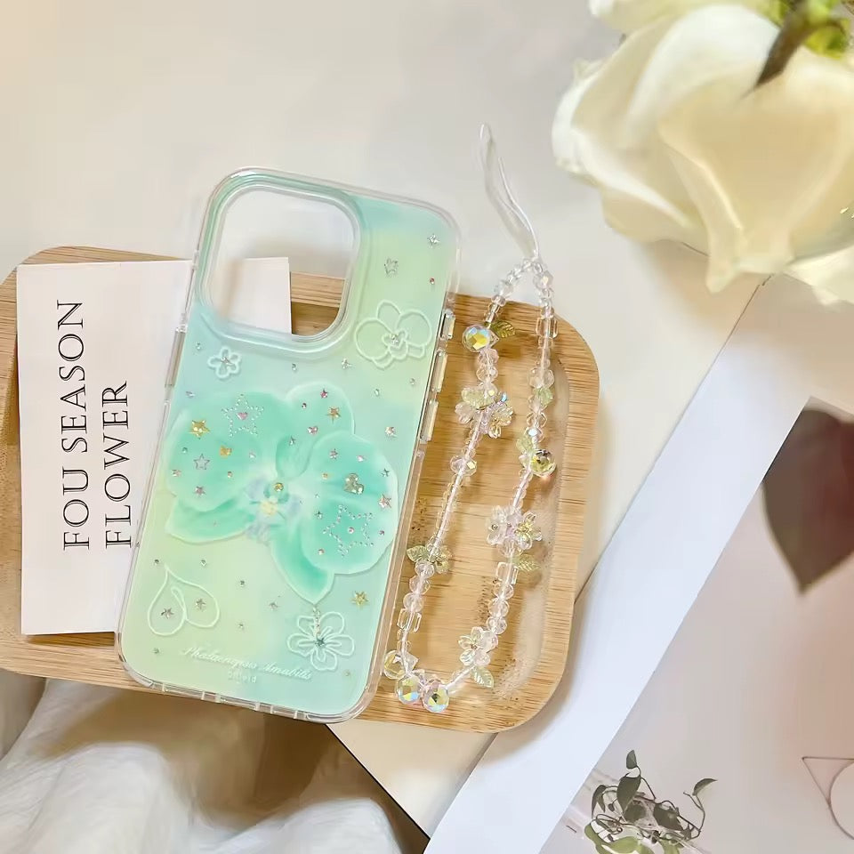 Phone case with decorative chain held by a hand on a light fabric background