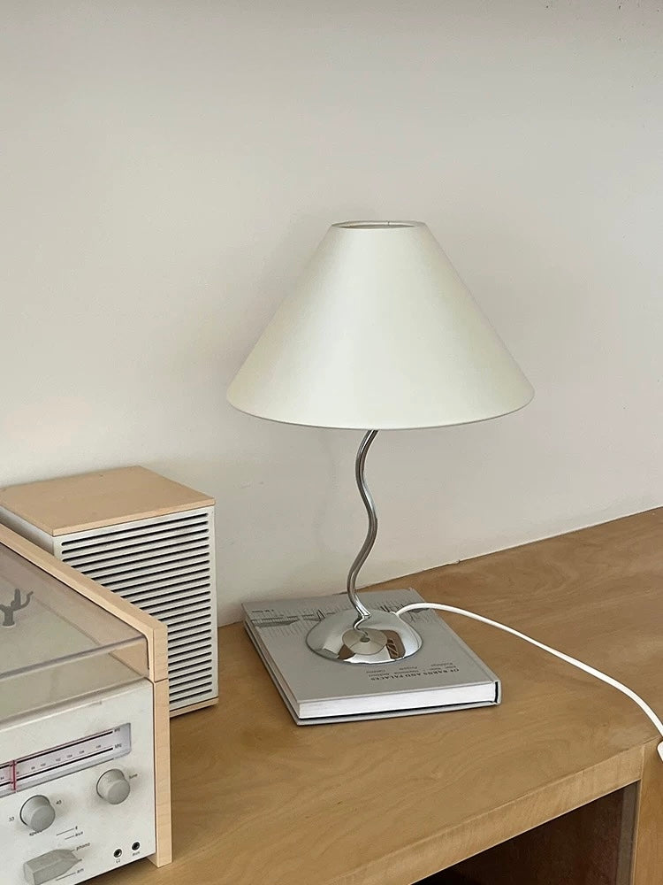 Table lamp on a wooden table with a neutral background