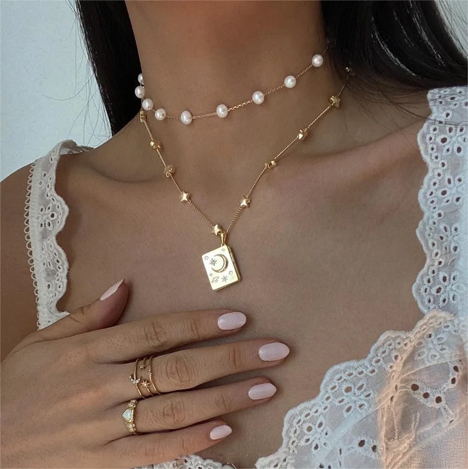 Stainless steel soulmate necklace with openable locket. Elegant heart and moon pendant design for romantic gifts.