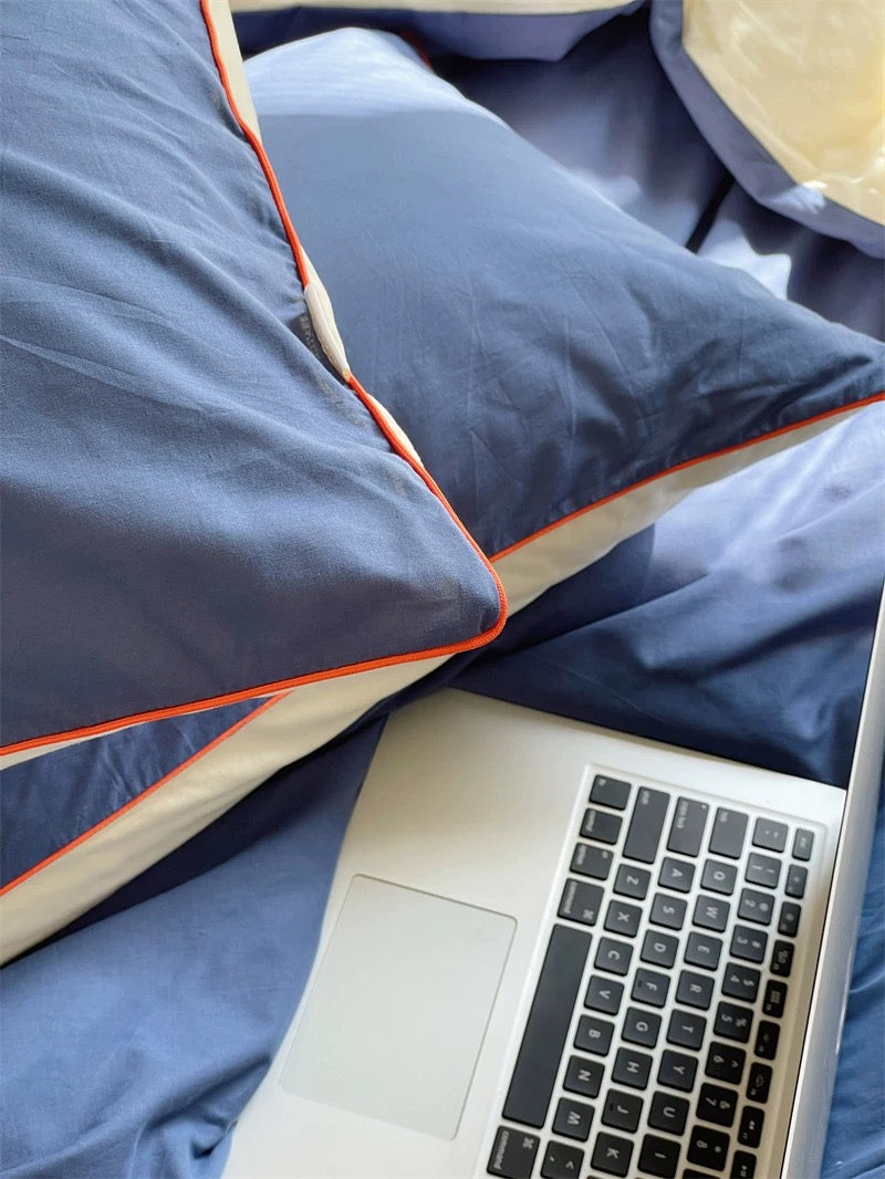 Navy washed cotton color block bedding set styled in minimalist bedroom.