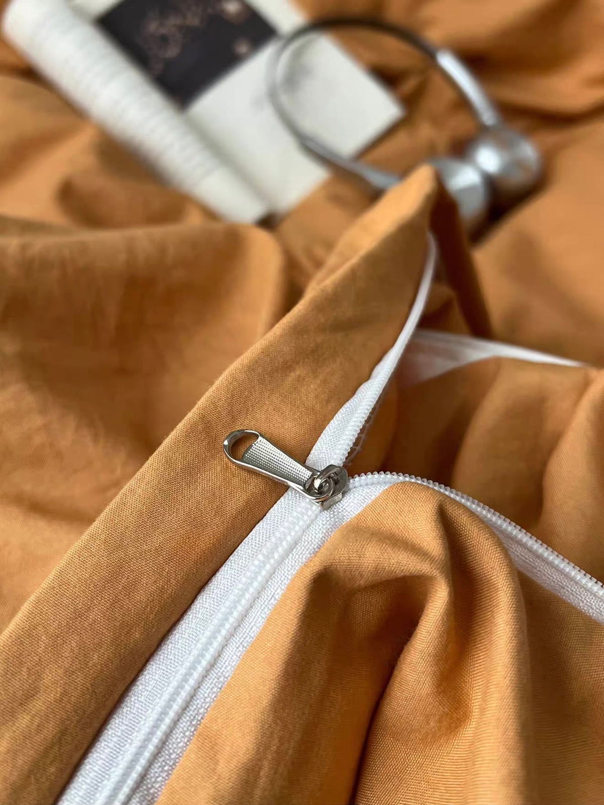 Close-up of orange fabric with a white edge detail