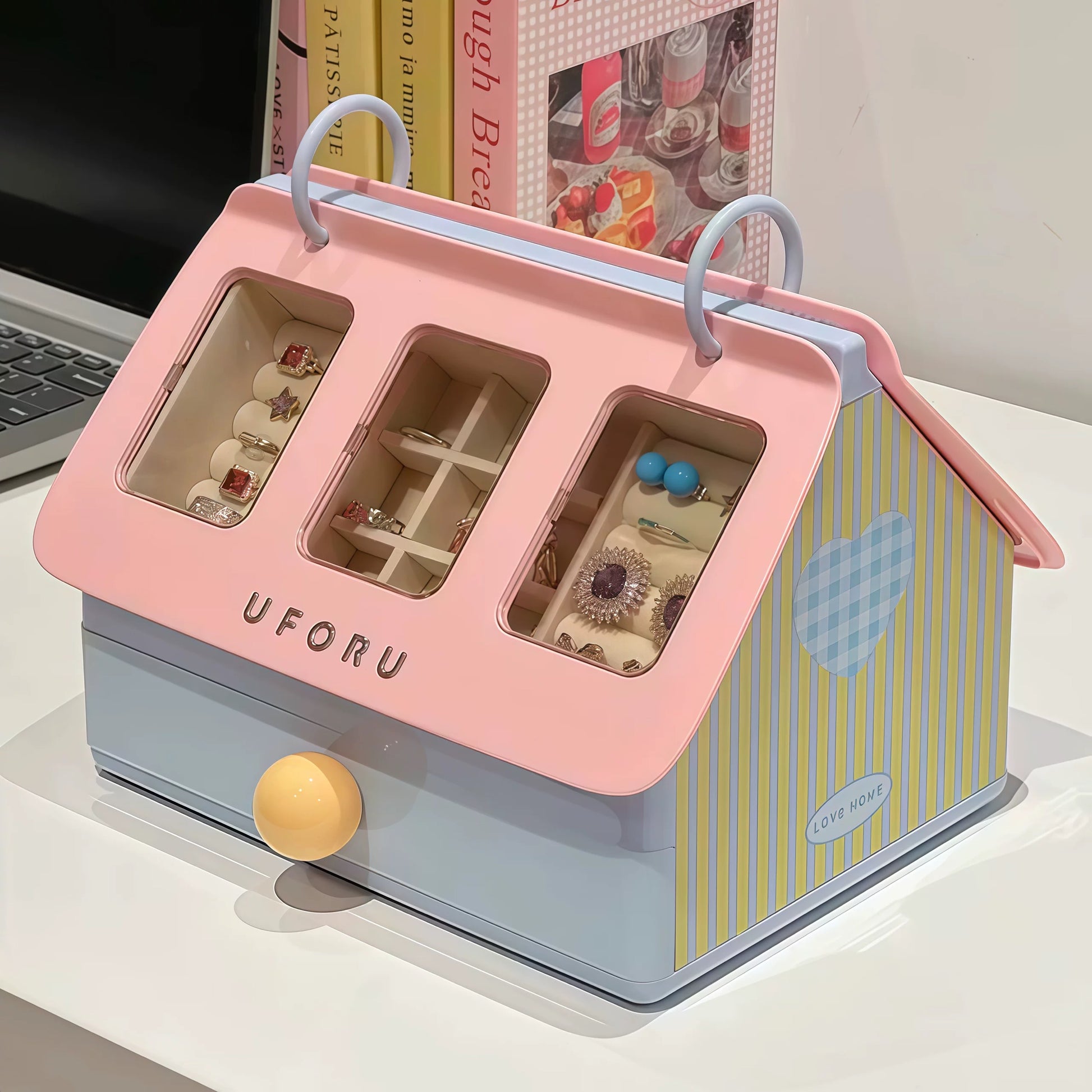 Pink and blue jewelry box with 'UFORU' branding on a white surface.