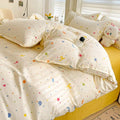 Folded pastel dotted comforter showing smooth polyester microfiber texture.