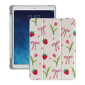 Tablet with a floral and bow patterned case on a white background