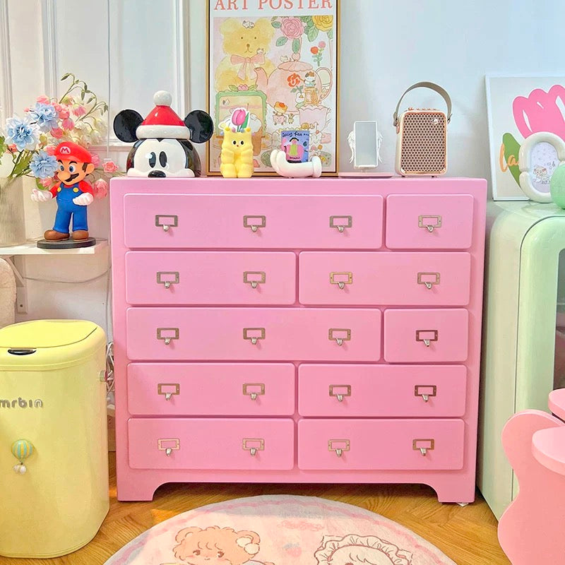Dopamine pink ten drawer cabinet styled as sideboard in playful living room interior