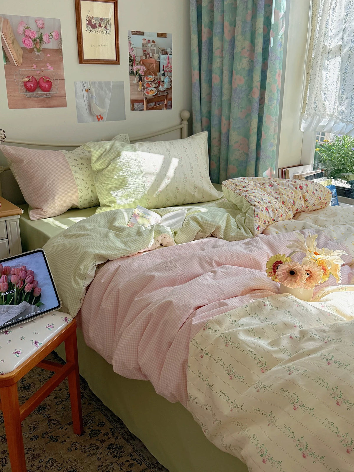 Pink patchwork bedding layered with cream and green floral prints