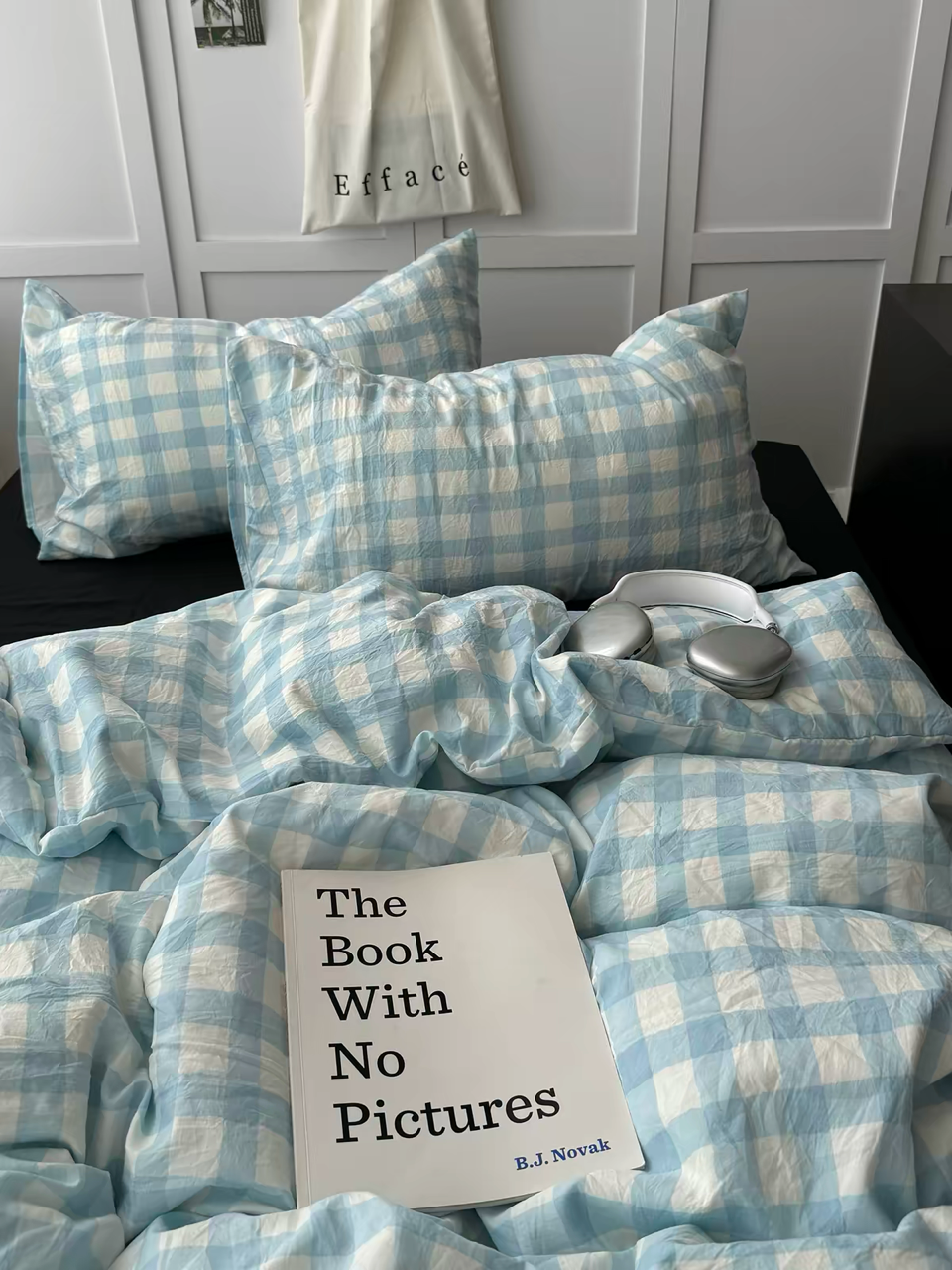 Preppy gingham duvet cover paired with black bedding on a light blue checked bed
