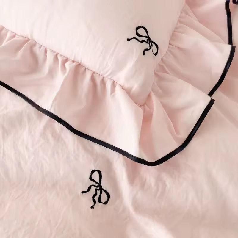 Girly room decor featuring soft pink ruffled bedding set