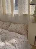 Soft girl bedroom styled with delicate pink floral duvet and fairy curtains