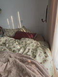 Delicate green floral duvet cover set. Includes flat sheet and pillowcases in 100% cotton for cozy and elegant bedroom decor.