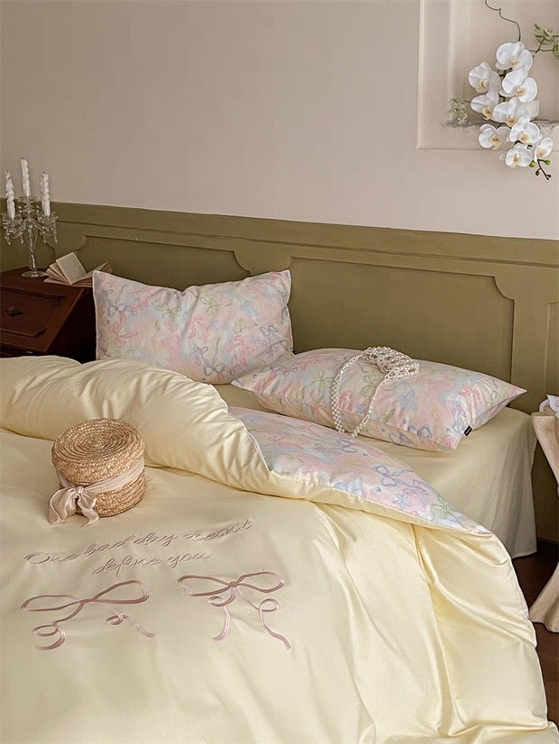 Neatly made bed with floral patterned pillows and embroidered bedding in a bedroom setting.