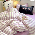 Purple striped cotton bedding set displayed on a neatly made bed in a soft girl aesthetic bedroom.