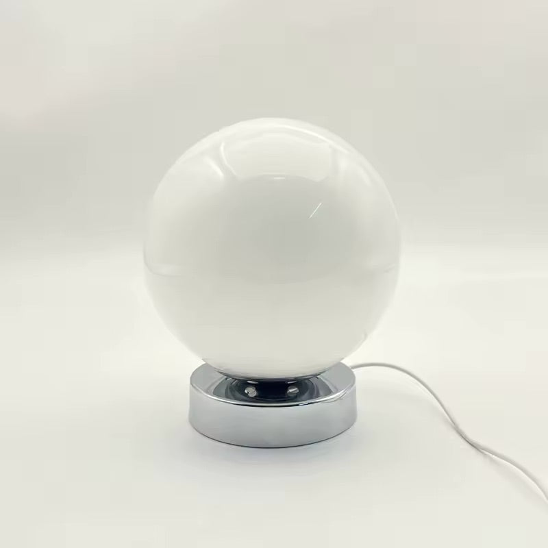 White spherical lamp with chrome base on a white background
