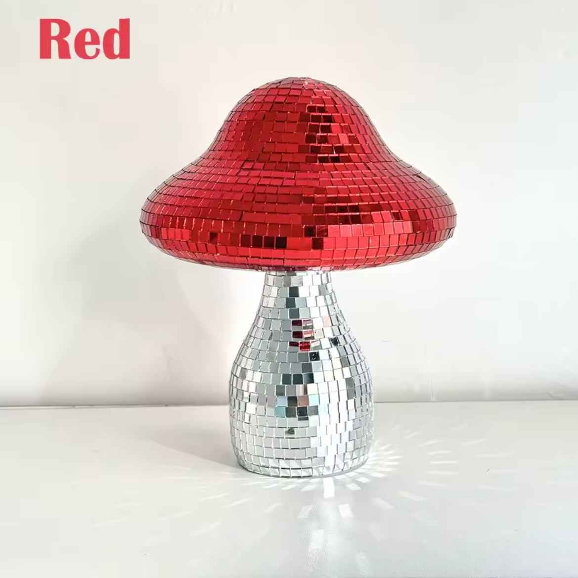 Close-up of quirky mushroom mirror with mirrored surface and sparkles