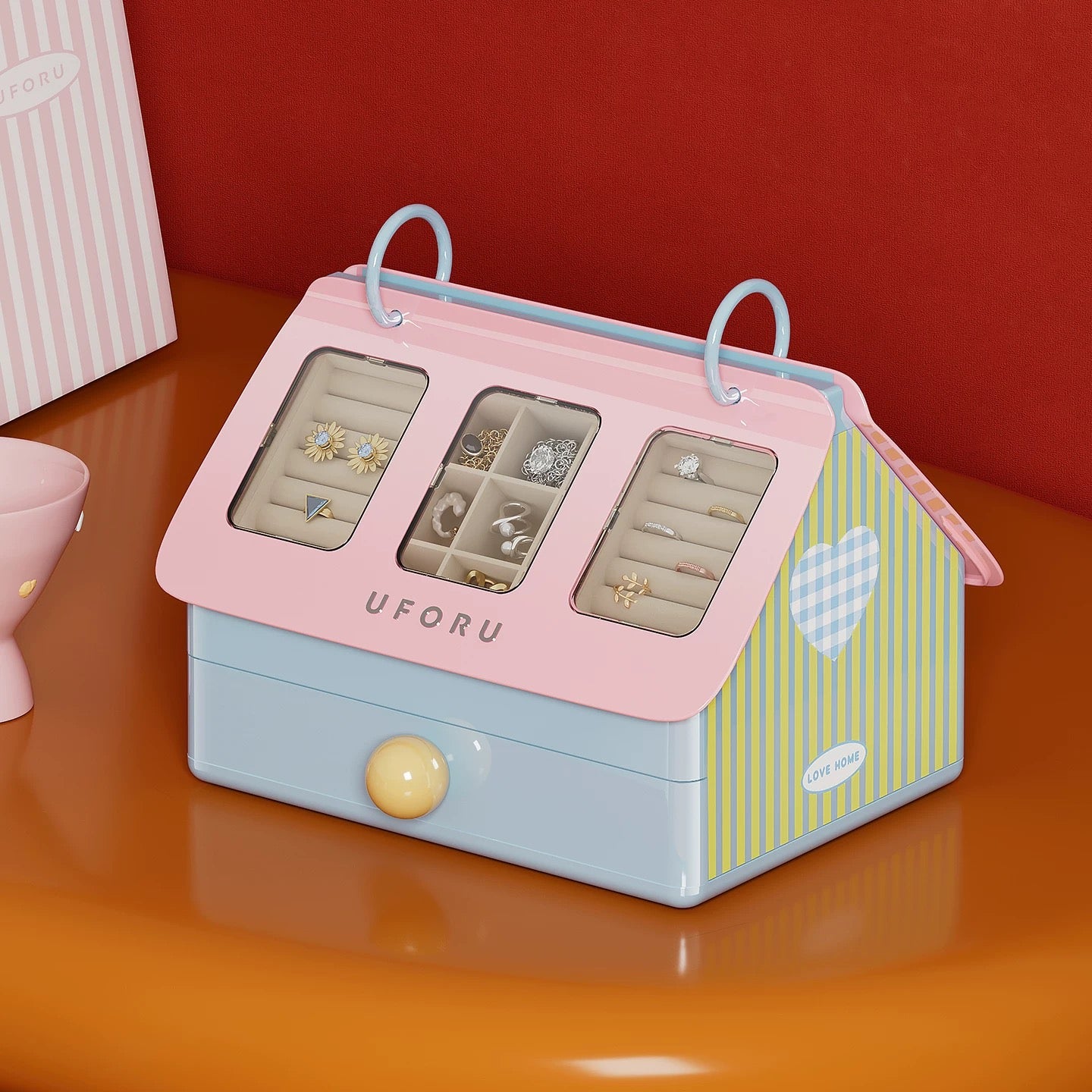 Pink and blue jewelry organizer with earrings on a red background