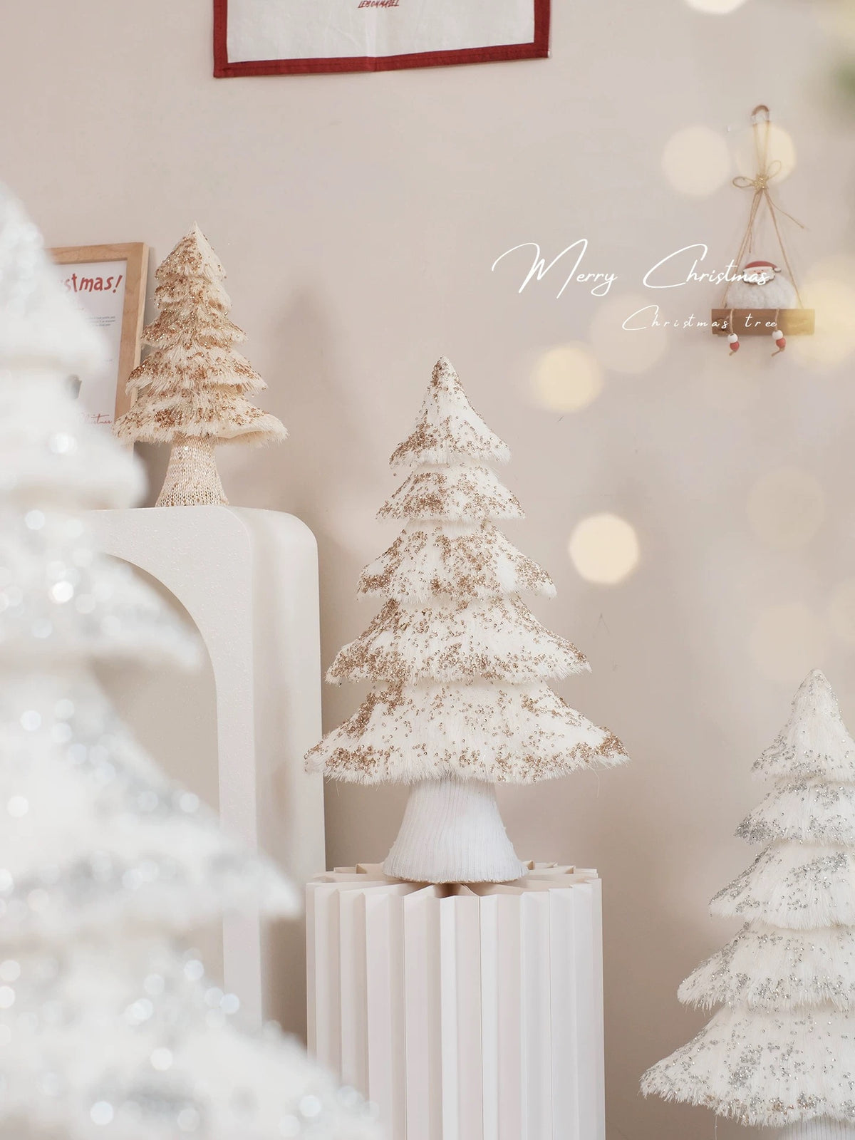 Scandinavian Christmas decor features white fringed trees arranged at different heights in a bright room.