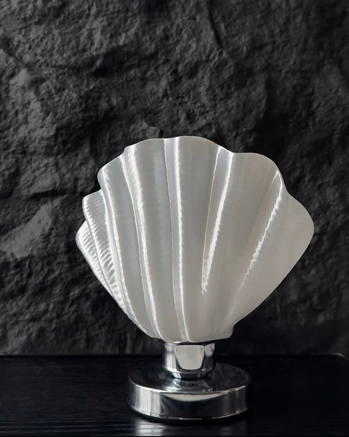 Shell inspired bedside table lamp with soft warm light creating calm cozy bedroom atmosphere