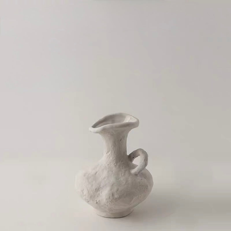 White ceramic vase on a light gray background