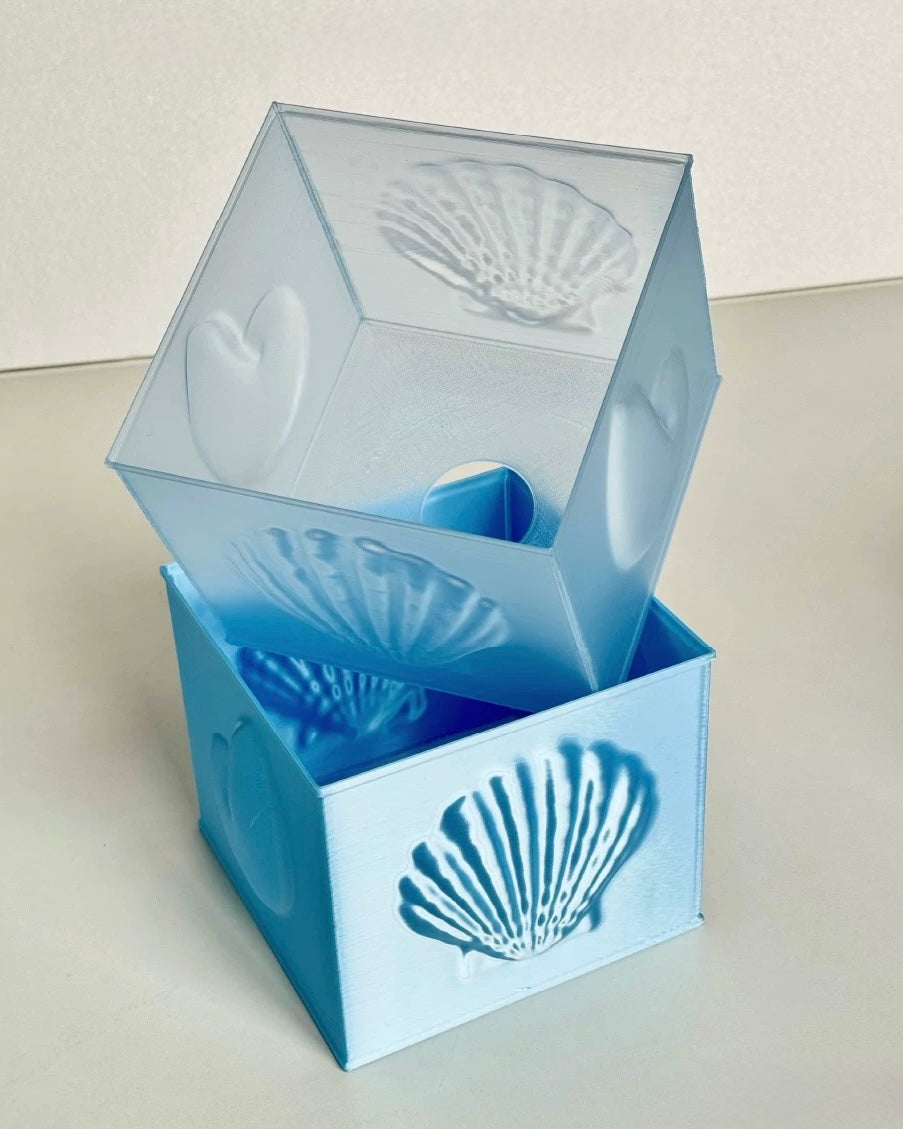 Sculptural blue seashell bedside lamp with soft ambient glow for coastal bedroom decor