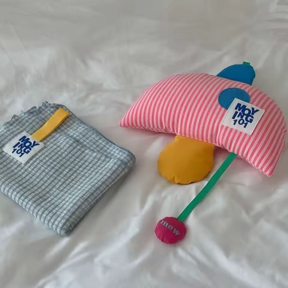 Two plush toys with striped hats and a small tag on a white background
