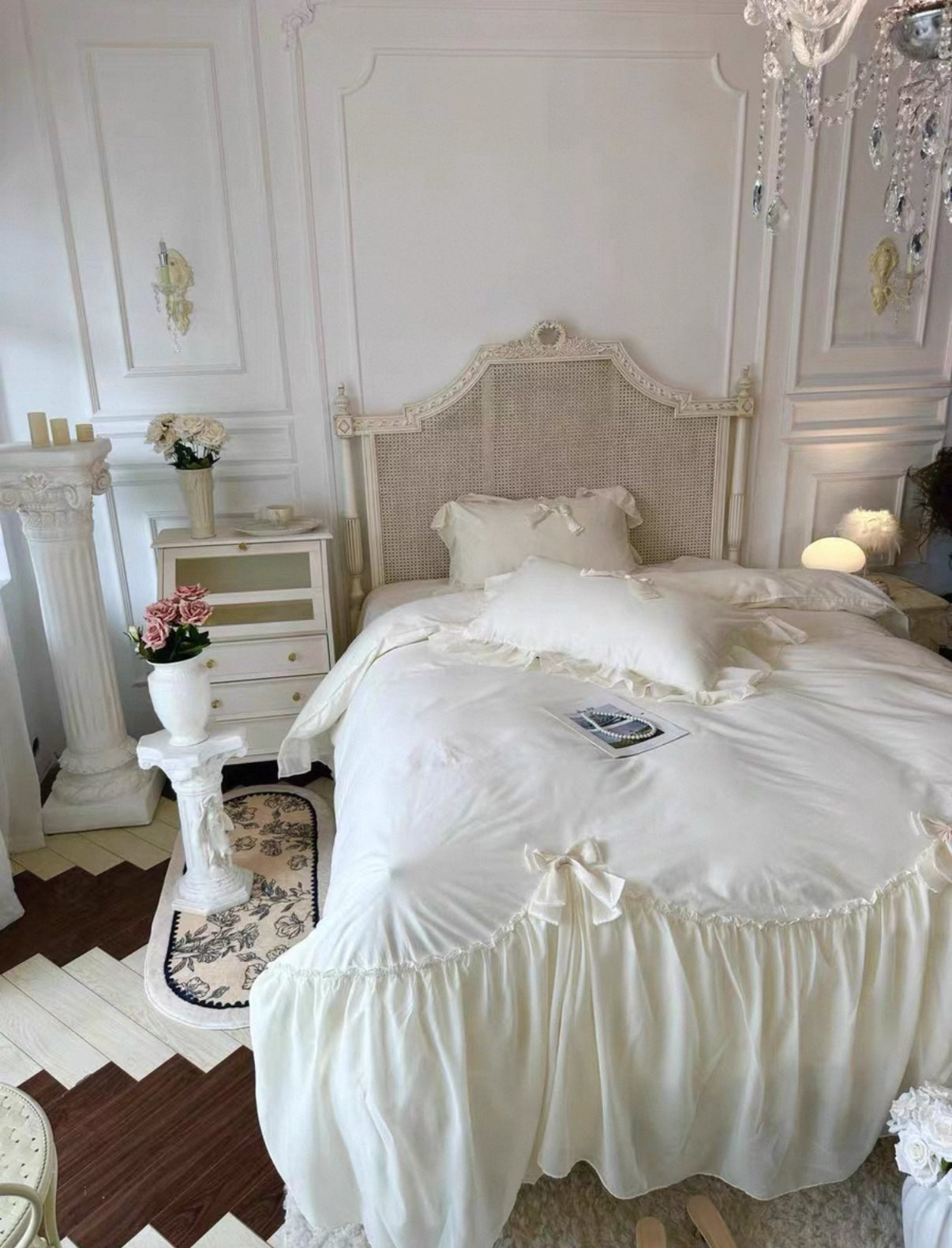 Delicate white bedspread on a bed in a stylish bedroom with decorative elements.
