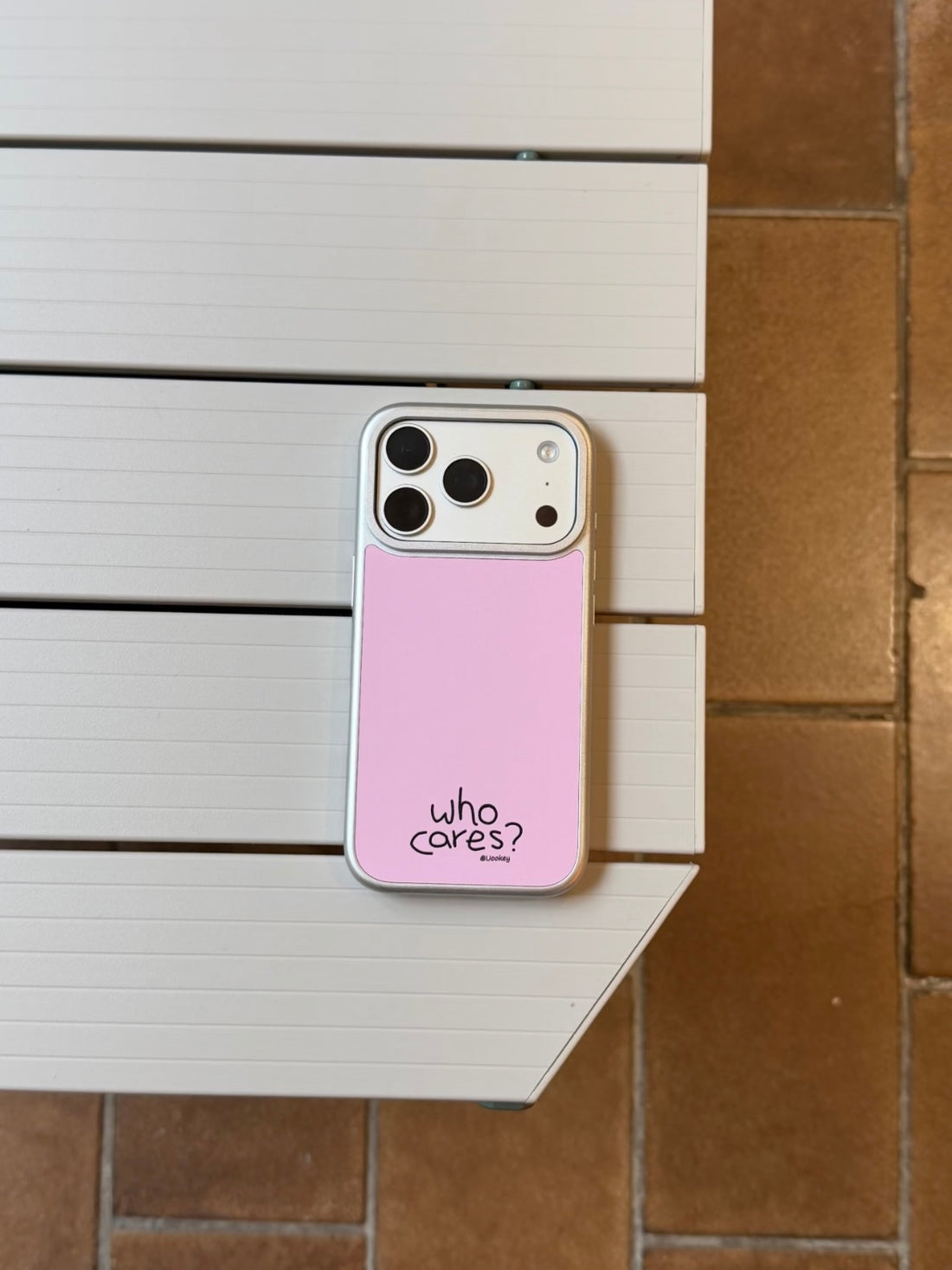 Soft Girl phone case in pale pink resting flat, with black lettering near the bottom of the back.
