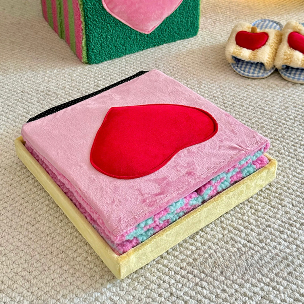 Pink heart storage stool shown laid flat with striped trim