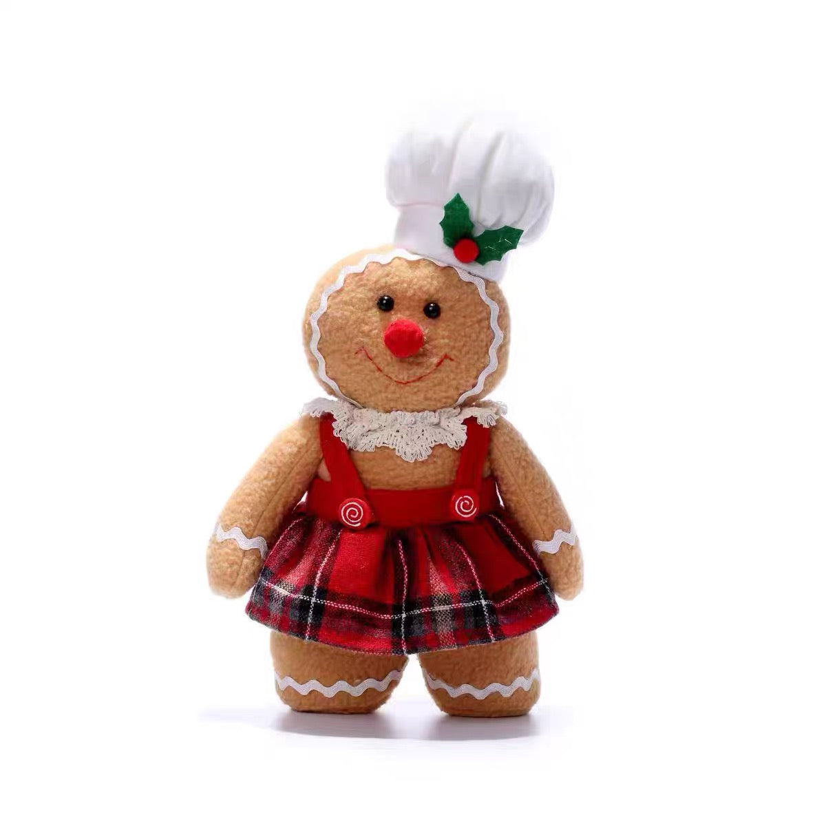 A standing gingerbread woman doll is shown from the front in a white chef hat, lace collar and plaid skirt.