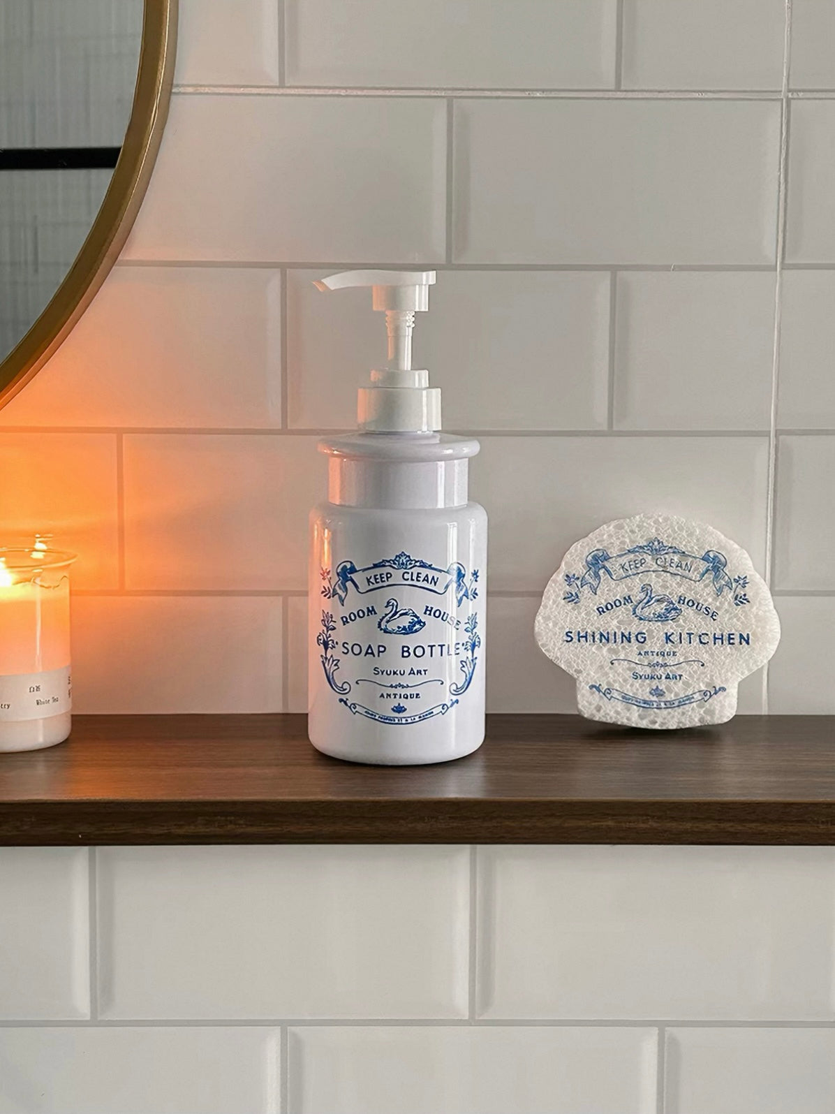 A swan soap bottle stands beside a matching sponge, with blue lettering visible against the white body.