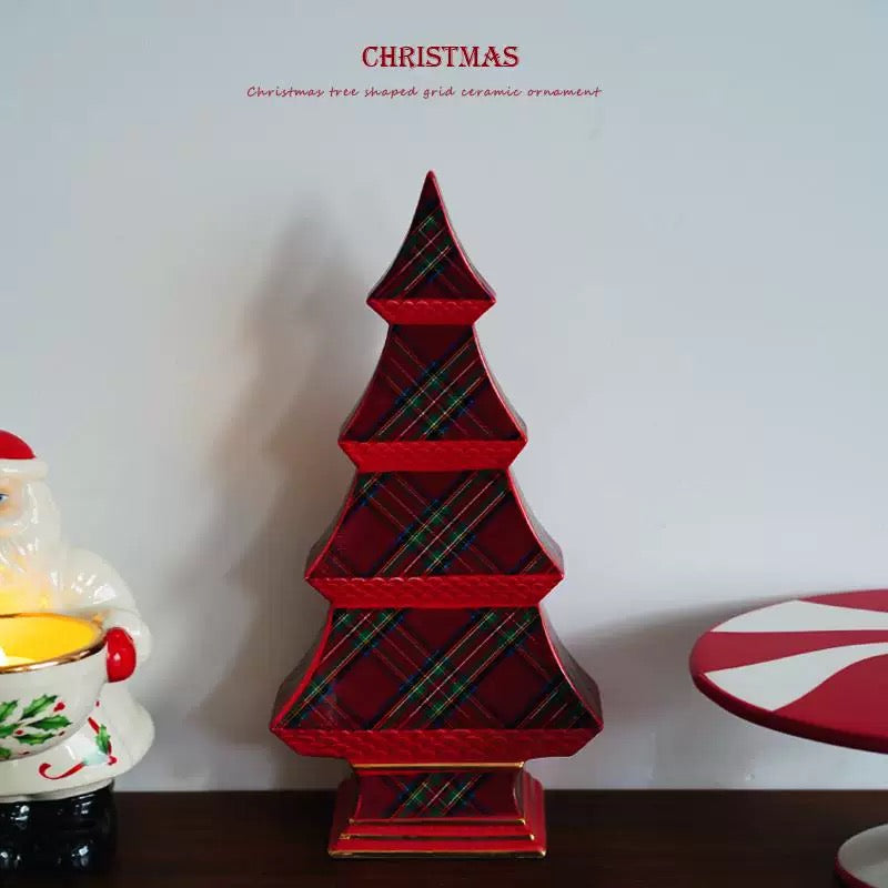 A tabletop Christmas tree in red plaid stands upright, with its pointed top and stepped base fully visible.