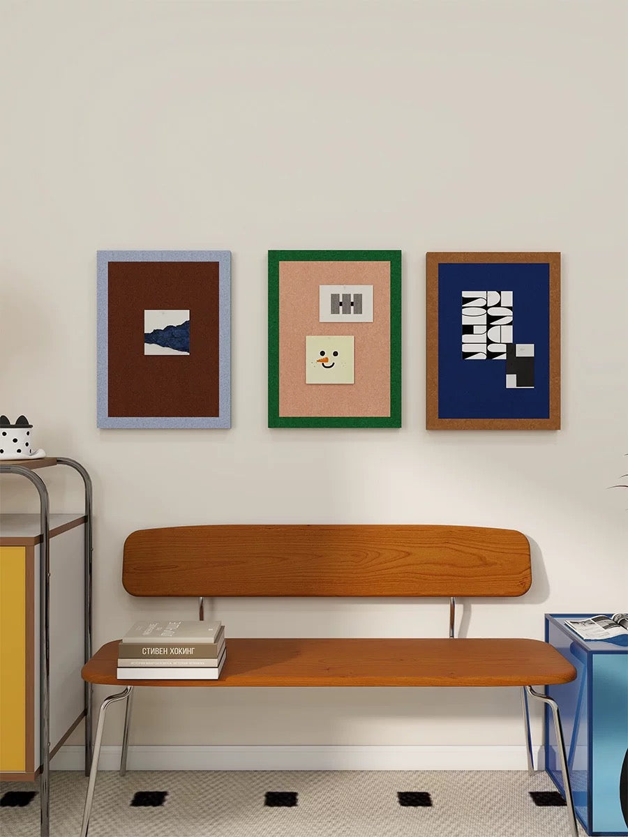 Two-tone felt pin boards arranged as colorful photo wall decor above a bench.