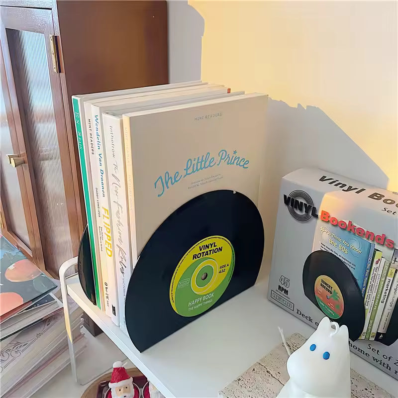 Stack of books with a vinyl record design on a shelf