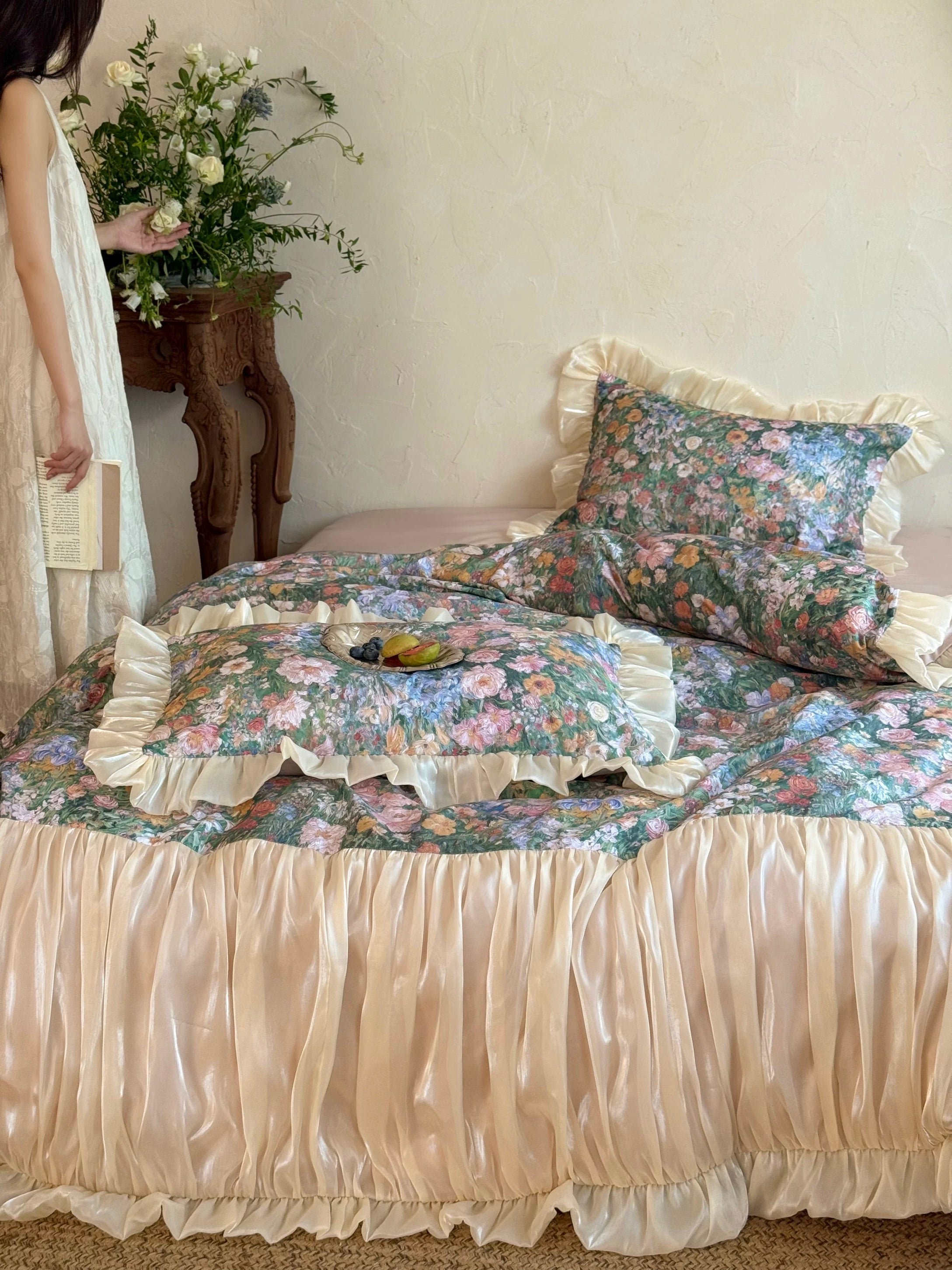 Floral bedding set on a bed with a person partially visible in the background.
