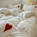 Soft girl aesthetic bedroom featuring heart embroidered bedding and plush toys.