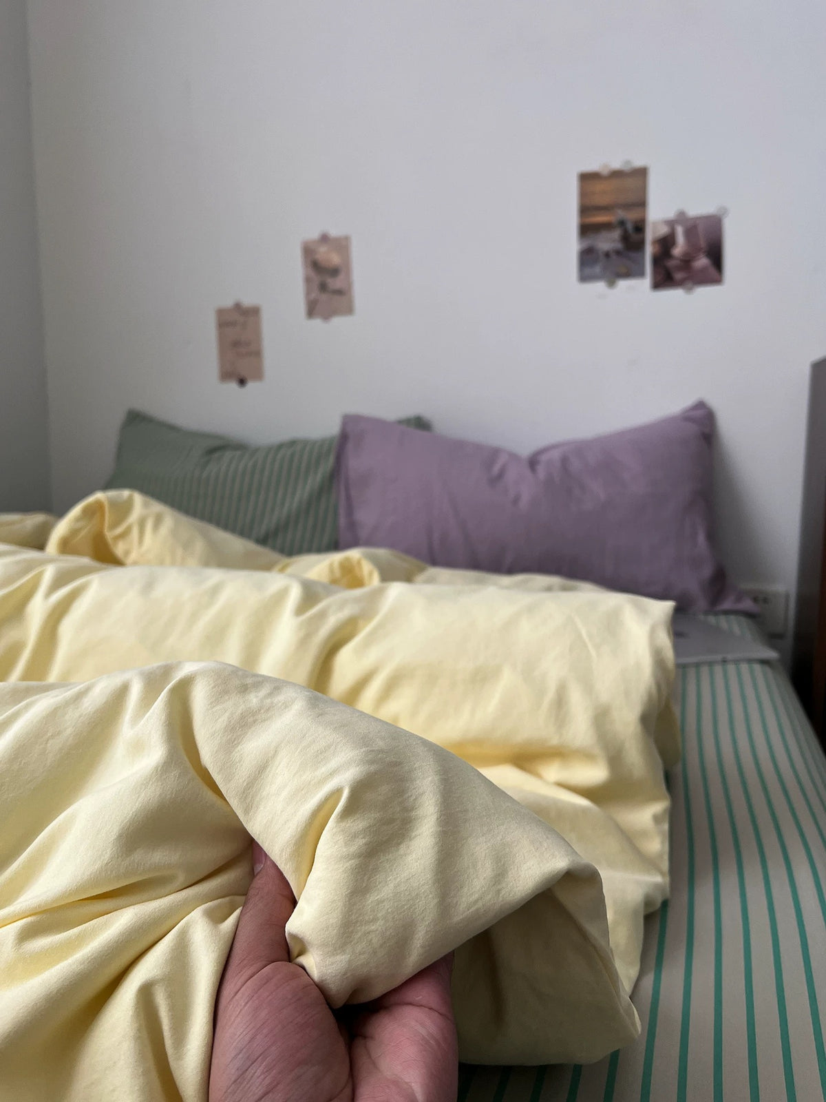 Close view of the butter yellow duvet cover with sage striped bedding