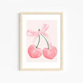 Feminine canvas wall art featuring bows and cherries in soft blush tones.