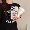 Person holding a phone with a cartoon case and a coffee cup.