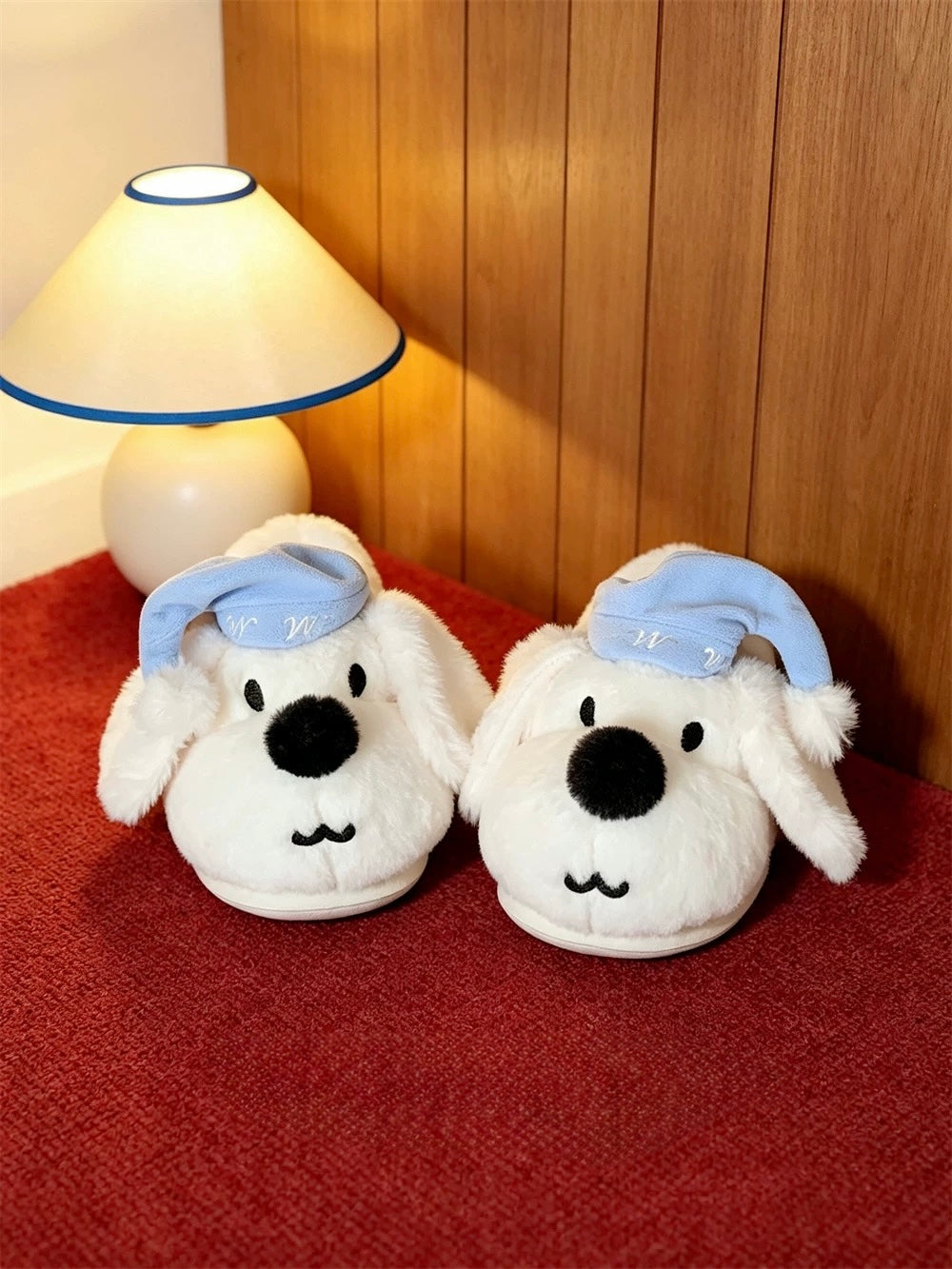 White puppy house slippers displayed under warm indoor lighting