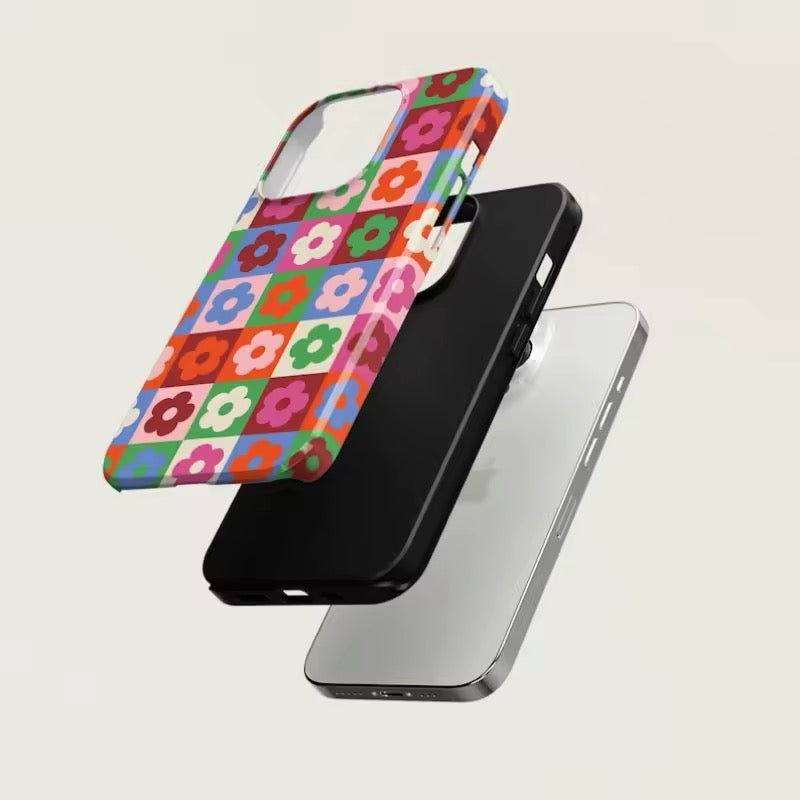 Full view of the colorful floral phone case for iPhone 16 Pro Max, styled against a minimalist backdrop