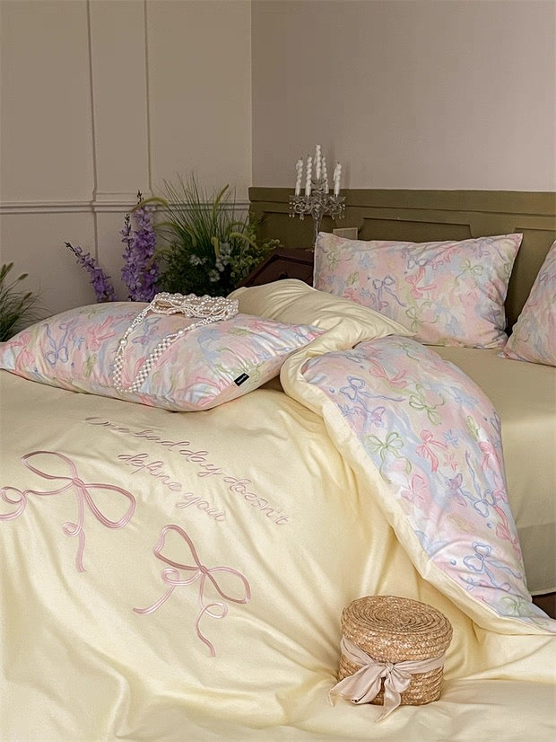Decorative bedspread with floral patterns and embroidery on a bed in a bedroom setting.
