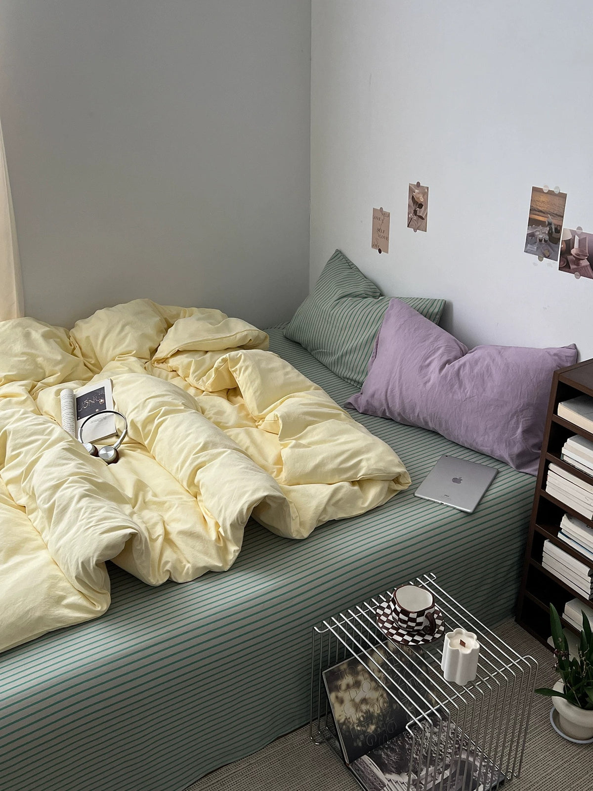 Yellow duvet cover set with sage pinstripe bedding and a lilac accent pillow
