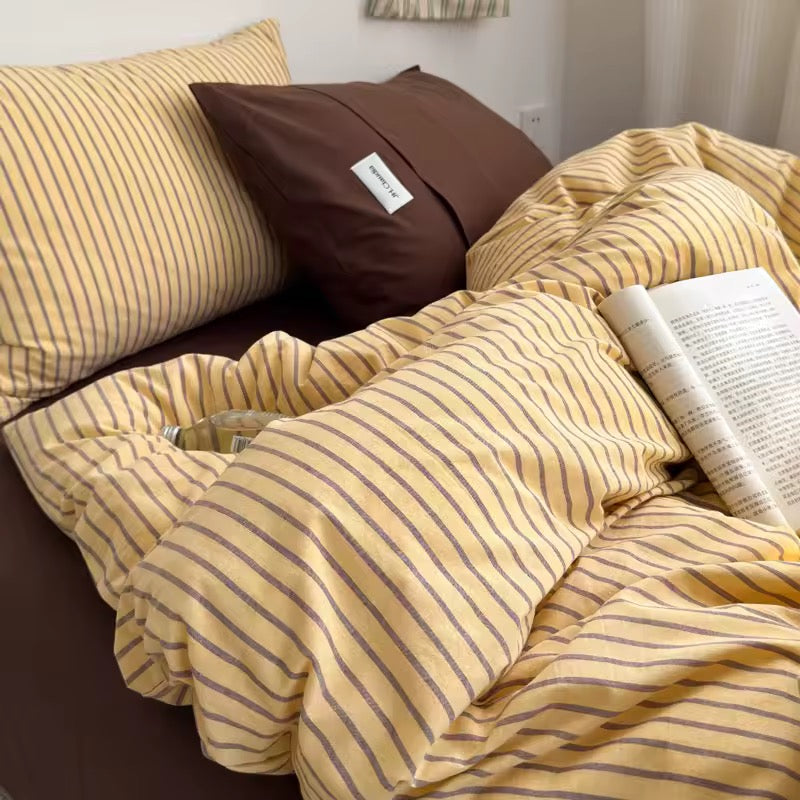 Warm yellow and beige striped duvet cover made from breathable cotton.
